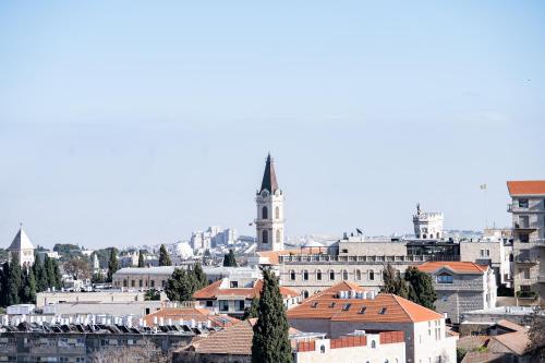 a view of a city with a clock tower at Isrentals Haneviim - ApartHotel In City Center in Jerusalem