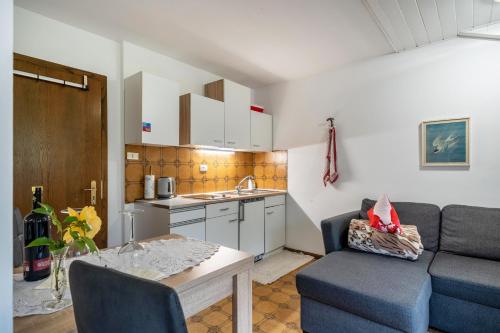 a living room with a couch and a table and a kitchen at Elisabeth in Lana