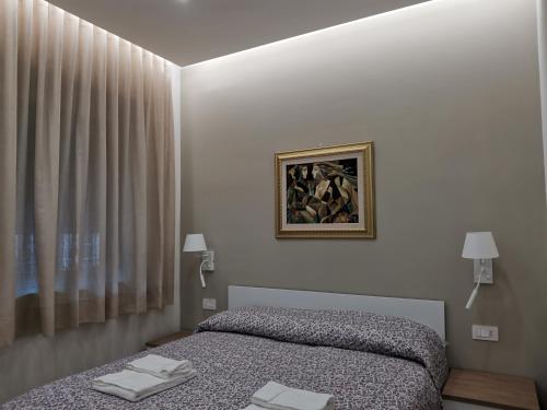 een slaapkamer met een bed en een foto aan de muur bij Palazzo Buscema - Casa & Vacanza in Crotone