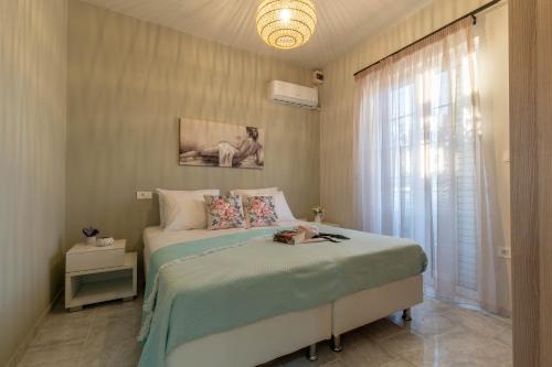 a bedroom with a bed and a window at Grande Terra in Kiotari
