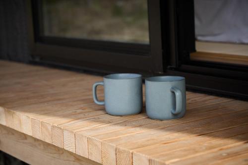 two coffee mugs sitting on a window sill at Villa 天ツ星 in Tahara