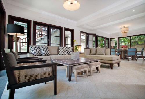 a living room with a couch and a table at Sundara Oceanside Villa in Tanah Lot