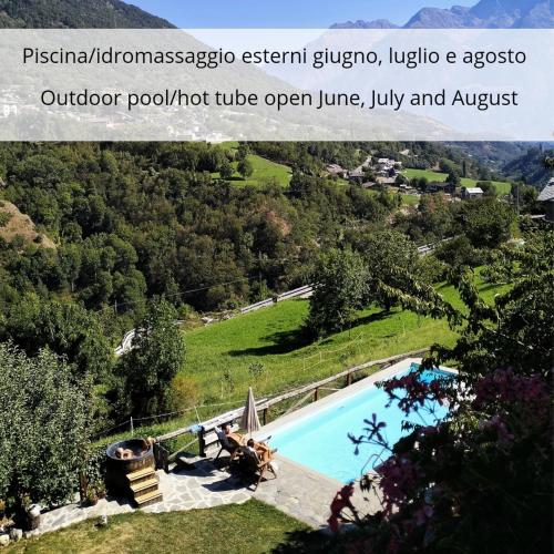 an image of a swimming pool with a view of a hill at La Fattoria di Roven in Gignod