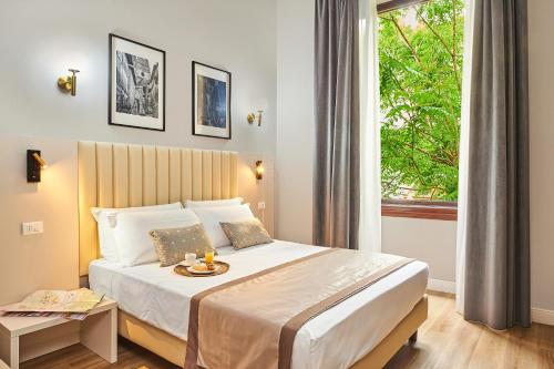 a hotel room with a bed and a window at Hotel Lombardi in Florence