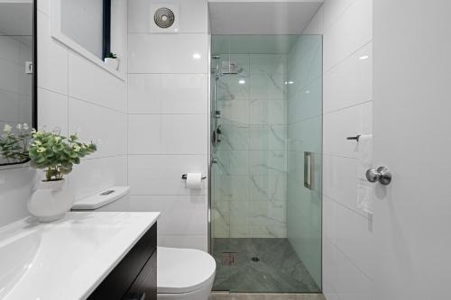 a bathroom with a shower and a toilet and a sink at Tasman Holiday Parks - Christchurch in Christchurch