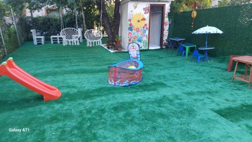 a backyard with a playground with a slide and a swing set at Diamond Kiten in Kiten