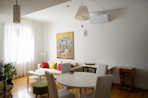 a living room with a table and a couch at Piazza Roma Apartment in Ascoli Piceno