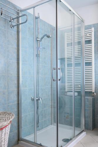 a shower with a glass door in a bathroom at Piazza Roma Apartment in Ascoli Piceno