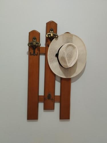 a straw hat is hanging on a wall at ISLAND TIME in Chios
