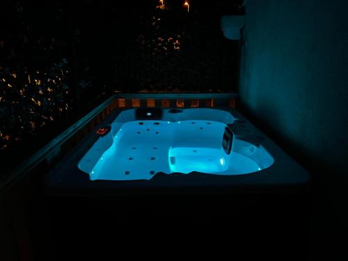 a jacuzzi tub in a dark room at night at Apartments Lira in Mlini