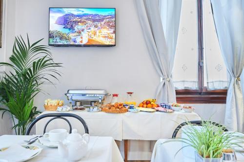 a table with food on it in a room at Hotel Lombardi in Florence