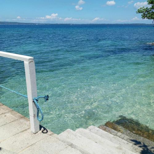 a view of the ocean with a rope in the water at Beachfront Mansion and Seascape Villas Calatagan with Outdoor Pool in Calatagan