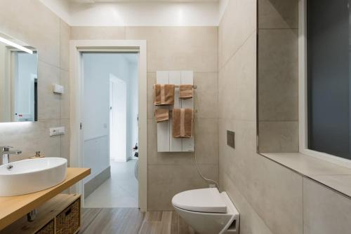 a white bathroom with a sink and a toilet at Apartment deluxe ground floor Venice/Treviso park in Silea