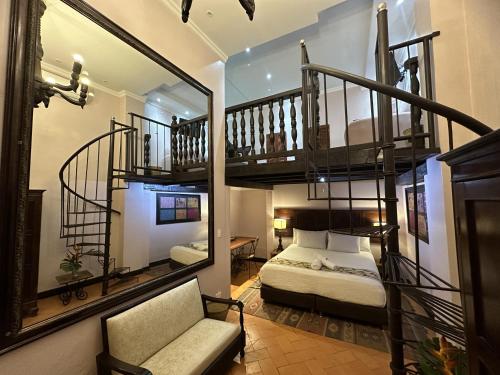 a bedroom with a bunk bed and a spiral staircase at Hotel Boutique Casa Córdoba Estrella in Cartagena de Indias