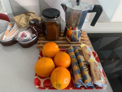 a pile of oranges on a counter with a blender at Picolo in Cee