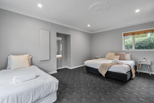a bedroom with two beds and a window at Tasman Holiday Parks - Christchurch in Christchurch