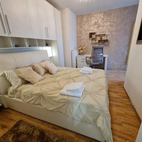 a bedroom with a large bed with towels on it at CRISTINCO PANORAMIC in Cluj-Napoca