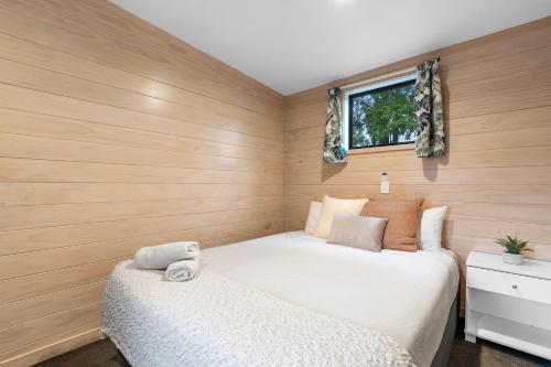 a small bedroom with a bed and a window at Tasman Holiday Parks - Christchurch in Christchurch