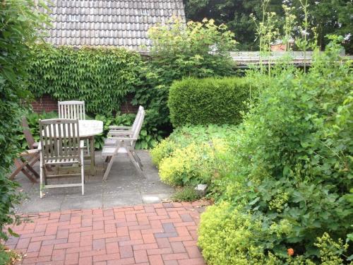 twee stoelen en een tafel in de tuin bij Liebevoll eingerichtetes Landhaus mit Charme und Seele und wunderschönem Garten in Hage