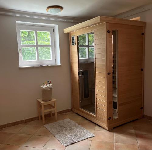a bathroom with a walk in shower next to a window at ALPHA in Badacsonytördemic