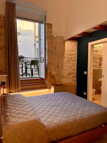 a bedroom with a bed and a large window at Blu Marina Apartment in Giovinazzo