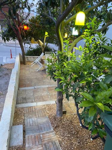a brick walkway with a bench in a garden at İZAN VİLLA BAKIŞ APARTMENTS in Bodrum City