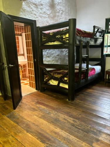 a room with two bunk beds in a room at Finca Campestre La Adelita B&B in Salento