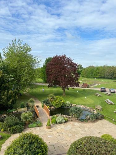 an aerial view of a park with a pond at Owston Hall Hotel in Doncaster