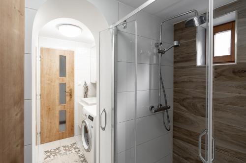 a bathroom with a shower and a sink at Chaty Daniela in Liptovský Ján