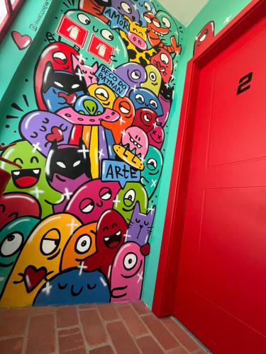 a wall with a bunch of cartoon characters on it at Pousada Bat N Breakfast No Beco do Batman in Sao Paulo