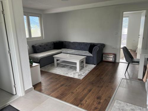 a living room with a couch and a table at Saraapartmani in Plav