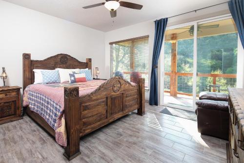 a bedroom with a wooden bed and a sliding glass door at Lazy Southern Getaway in Canyon Lake