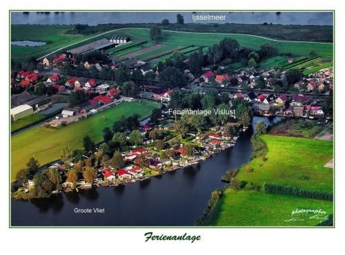an aerial view of a village on a river at Chalet direkt an der Gracht mit eigenem Bootsanlegesteiger in Wervershoof