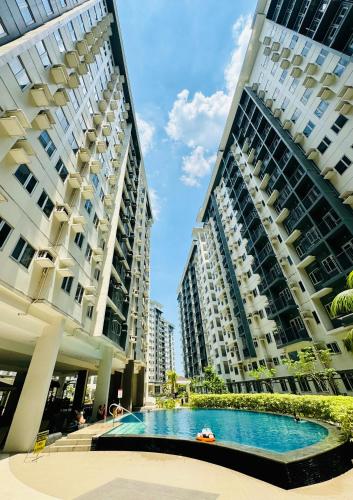 two tall buildings with a swimming pool between them at SMDC Vine Residences Condo in Manila