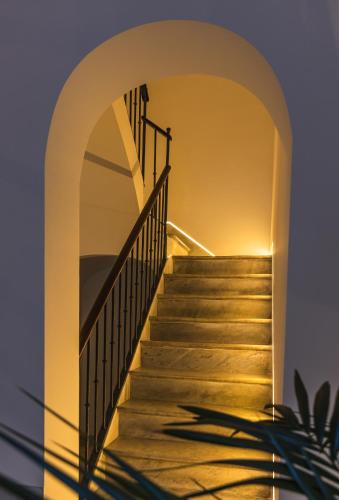 a staircase leading up to a house with an archway at Candelaria10 in Cádiz
