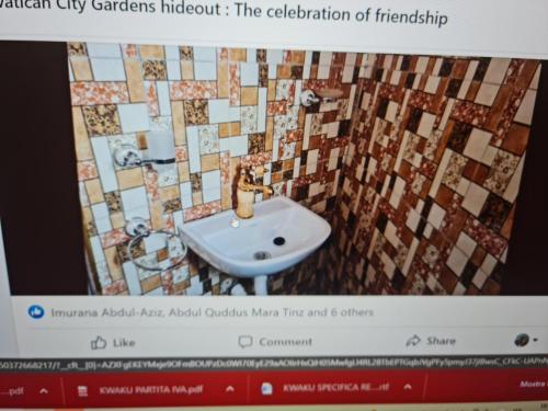 a television screen showing a bathroom with a sink at Vatican city gardens hideout kaleo in Wa