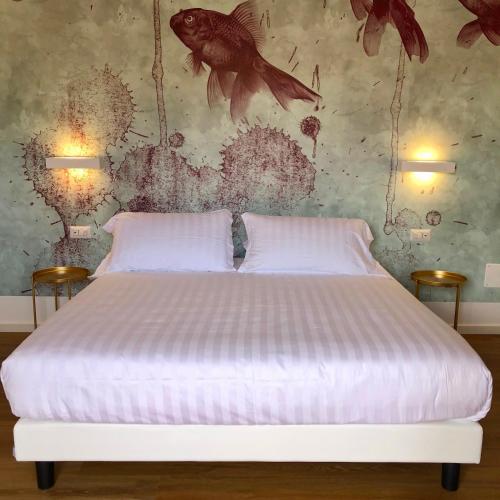 a bed with two white pillows in a bedroom at Il Borgo Boutique Rooms by KasaVacanze in Porto San Paolo
