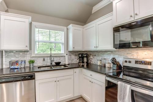 a kitchen with white cabinets and a sink at Eureka Springs Family Home - half Mi to Marina! in Eureka Springs