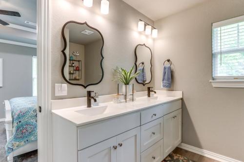 a bathroom with two sinks and two mirrors at Eureka Springs Family Home - half Mi to Marina! in Eureka Springs
