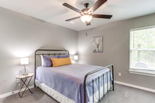 a bedroom with a bed and a ceiling fan at Eureka Springs Family Home - half Mi to Marina! in Eureka Springs