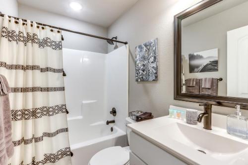 a bathroom with a sink and a toilet and a mirror at Eureka Springs Family Home - half Mi to Marina! in Eureka Springs