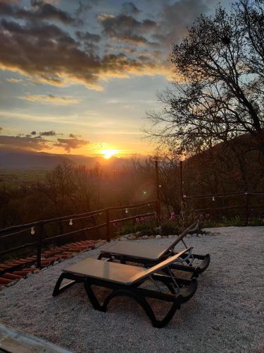 a picnic table with the sunset in the background at B&B LE GRETTE in Gioia dei Marsi