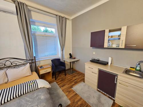 a bedroom with a bed and a desk and a sink at Soba 4 v Pekrski vili in Limbuš