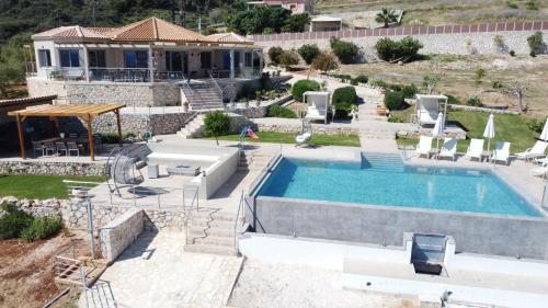 a villa with a swimming pool and a house at Il sogno di Zante in Skinária
