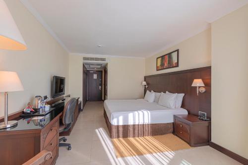 a hotel room with a bed and a desk at Crowne Plaza Antalya, an IHG Hotel in Antalya