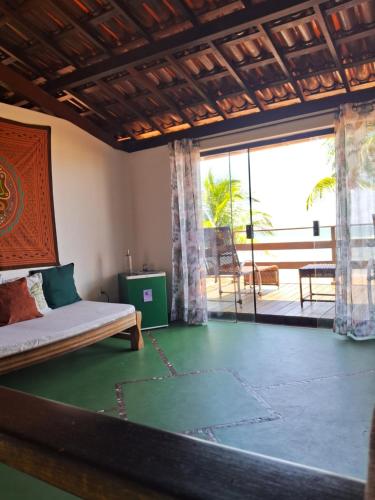 a bedroom with a bed and a view of the ocean at Casa Del Mar in Marau