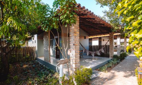 a house with a porch with a fence at Pousada Rancho das Dunas in Santo Amaro