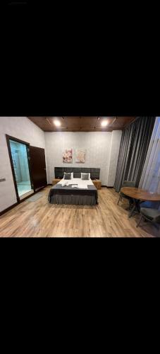 een grote kamer met een bed en een tafel bij SECRET HOTEL in Baku