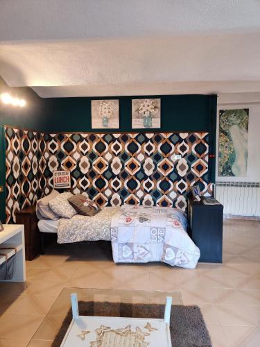 a bedroom with a bed and a wall of wine bottles at B&B LE GRETTE in Gioia dei Marsi