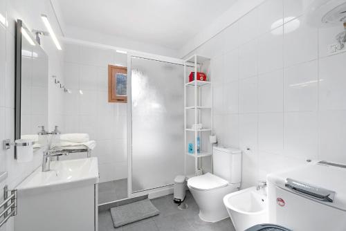 a white bathroom with a toilet and a shower at Ocean Park 311 in Adeje